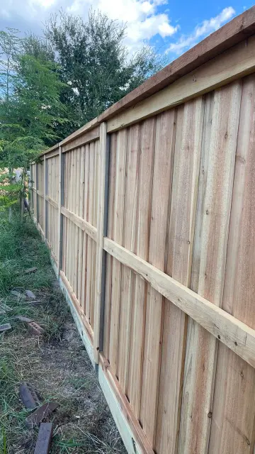 Wood privacy fence with durable black metal posts – Professional fence installation Houston TX | APX Pro