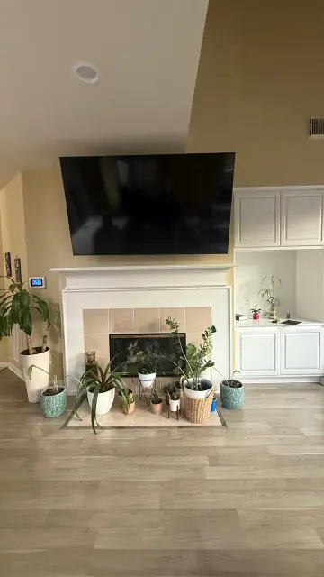 Finished living room remodel featuring white fireplace mantel and engineered hardwood flooring – Houston TX interior project