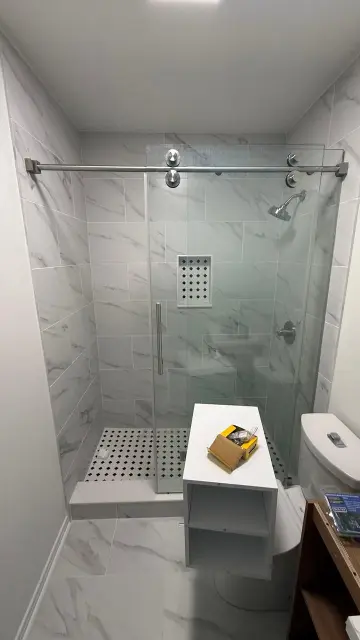 Modern bathroom remodel with walk-in marble-look shower and porcelain tile flooring – Houston Texas bathroom renovation